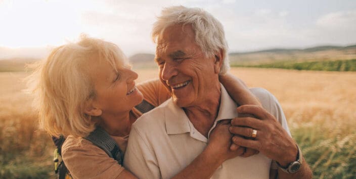 Photo of an elderly couple, who still enjoy in each other, is on a hiking trip together