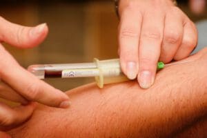 cholesterol medication being injected into man's arm