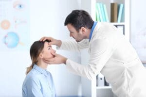 eye doctor examining woman's eye