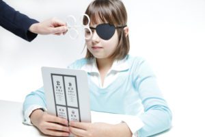 young girl doing at-home vision test