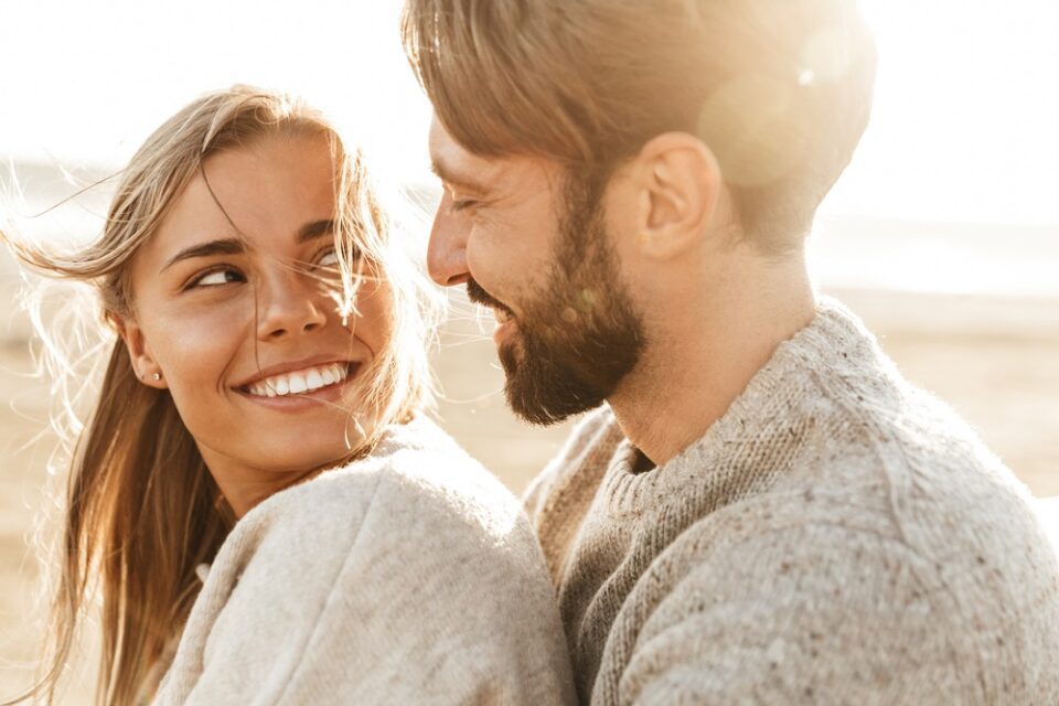 A young couple smiling thanks to the crisp, clear vision from LASIK at NVISION Eye Centers 