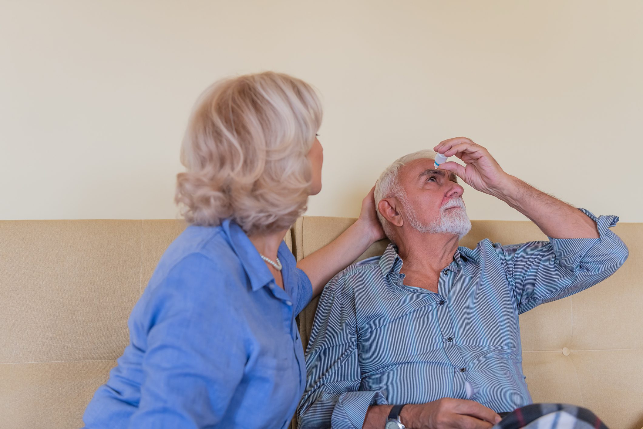 A man using eye drops for glaucoma treatment