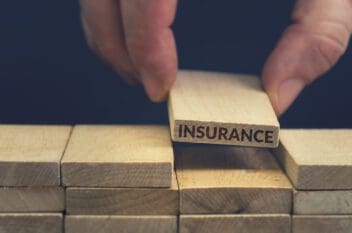 Insurance word written on wood block