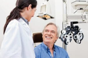 Smiling mature patient consulting with optometrist for an eye checkup