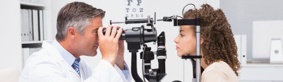 Woman doing eye test with optometrist in medical office
