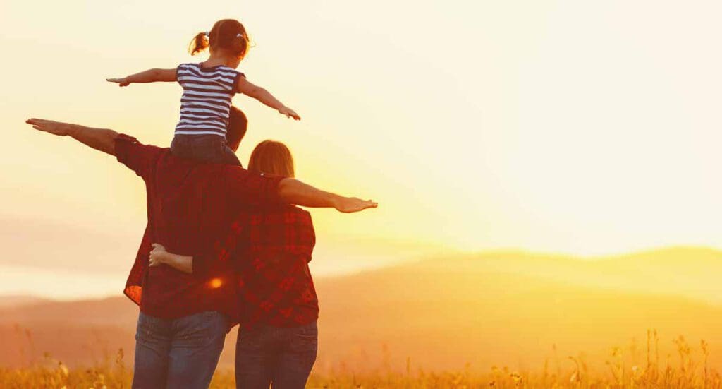 happy family looking off at sunset