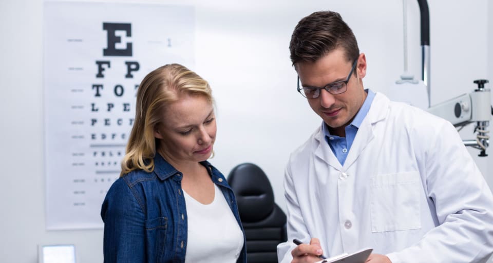 woman talking with eye doctor