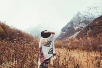 woman in mountain valley wearing hat