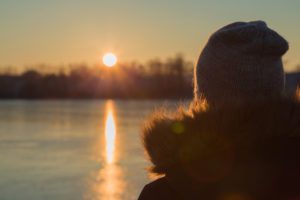 young woman staring at the sun