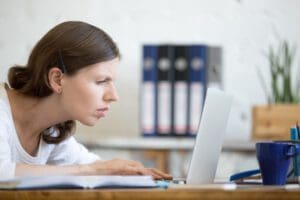 woman squinting at computer screen