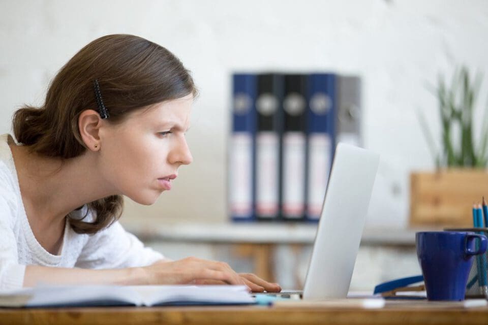 woman squinting at screen